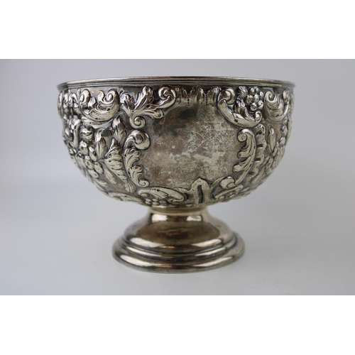 293 - An Edwardian silver rose bowl, of circular form, with roses and foliate decoration, raised on steppe... 