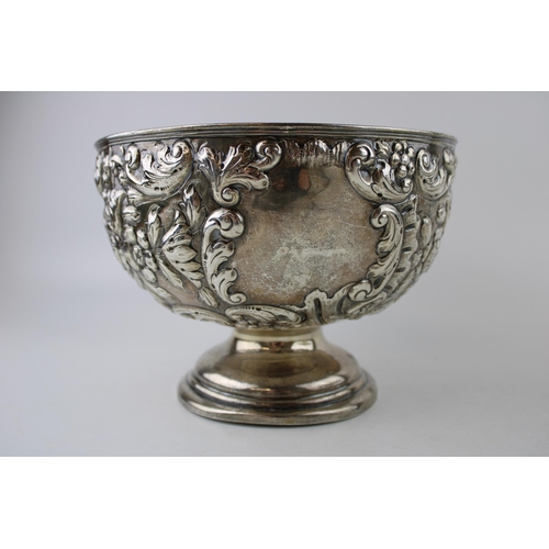 293 - An Edwardian silver rose bowl, of circular form, with roses and foliate decoration, raised on steppe... 