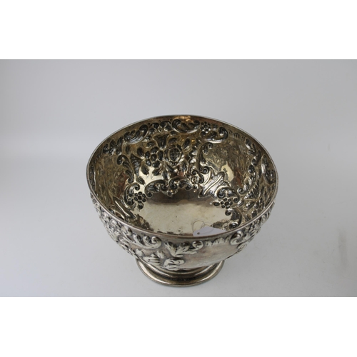 293 - An Edwardian silver rose bowl, of circular form, with roses and foliate decoration, raised on steppe... 