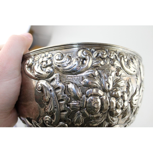 293 - An Edwardian silver rose bowl, of circular form, with roses and foliate decoration, raised on steppe... 