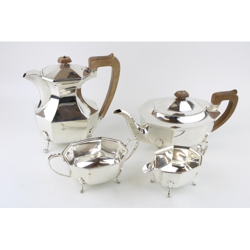 295 - A late Art Deco silver tea set, of classical curvilinear form, comprising tea pot and hot water jug ... 