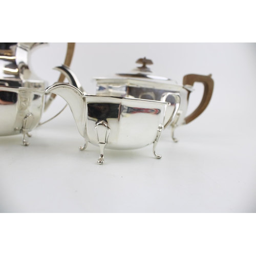 295 - A late Art Deco silver tea set, of classical curvilinear form, comprising tea pot and hot water jug ... 