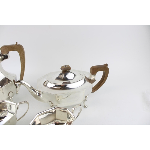 295 - A late Art Deco silver tea set, of classical curvilinear form, comprising tea pot and hot water jug ... 