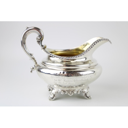 298 - A William IV silver cream jug, with gilt interior, presentation engraved, Edward, Edward junior, Joh... 