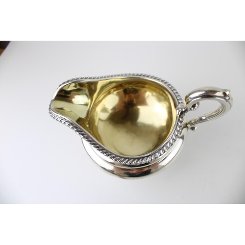 298 - A William IV silver cream jug, with gilt interior, presentation engraved, Edward, Edward junior, Joh... 