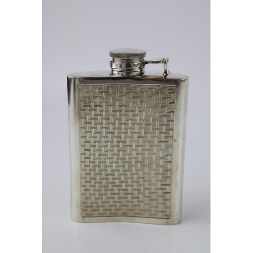 312 - Silver hip flask with engine turned decoration. Weight 151g.