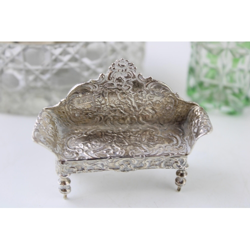 314 - Silver to include a miniature model of an arched back settee, a silver topped glass jar with Reynold... 