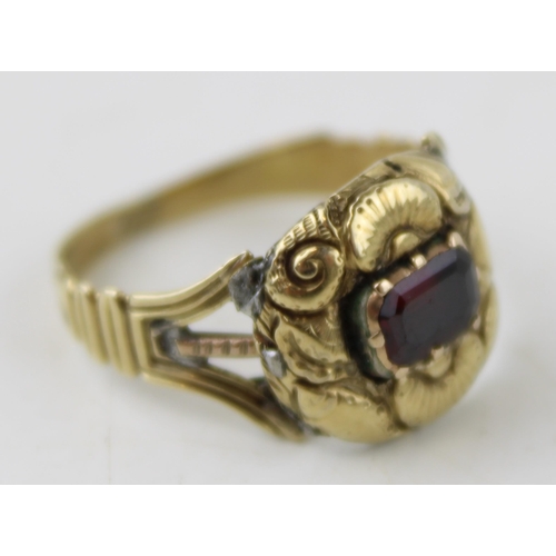 345 - A 19th century mourning ring, tests as 9ct gold or better, inset with a garnet and monogram engraved... 