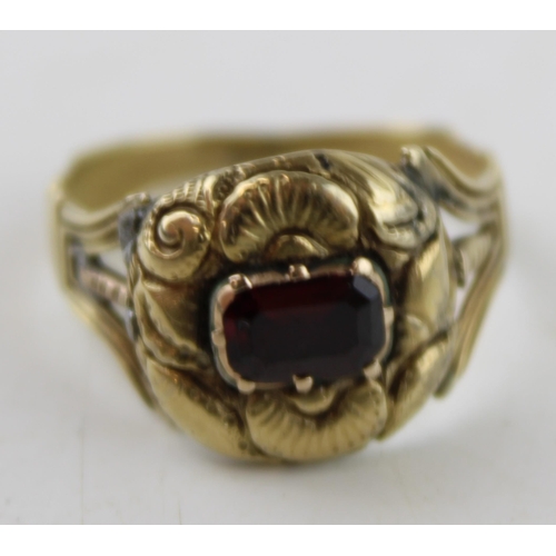 345 - A 19th century mourning ring, tests as 9ct gold or better, inset with a garnet and monogram engraved... 