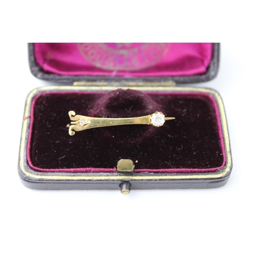 348 - An 18ct gold brooch in the form of a stylised Eiffel tower, set with an old cut diamond to the top, ... 