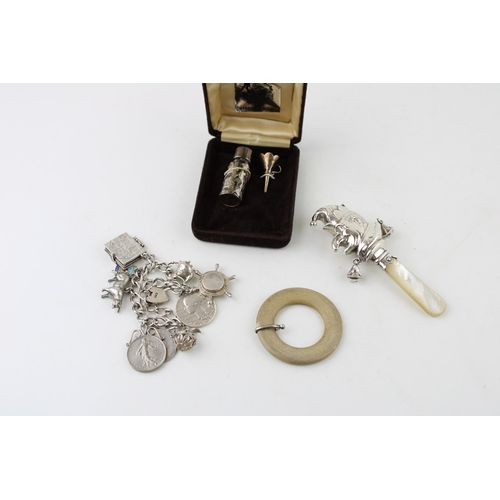 351 - A group of silver comprising a silver cased small scent bottle and funnel, a silver charm bracelet w... 