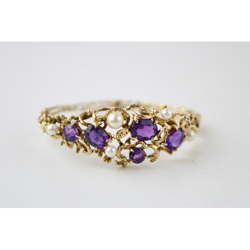 352 - A 9ct gold amethyst and pearl bangle set with five amethysts and four pearls in an organic scrolling... 