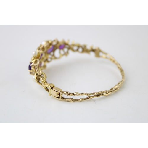 352 - A 9ct gold amethyst and pearl bangle set with five amethysts and four pearls in an organic scrolling... 