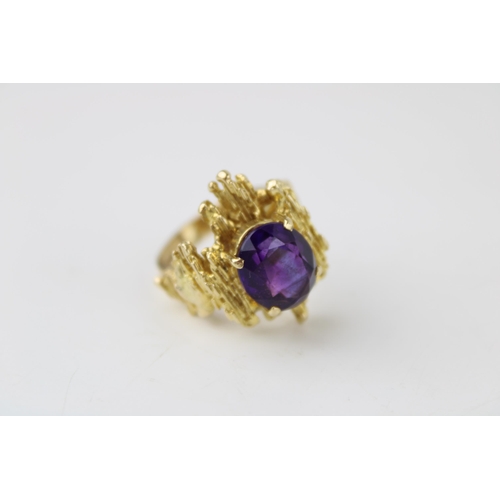 353 - A 9ct gold and amethyst ring of brutalist form circa 1970, the oval cut amethyst of approximately 12... 