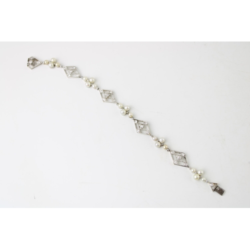 358 - An Art Deco, diamond, pearl and platinum set bracelet, of ten alternating diamond shaped panels, 14.... 