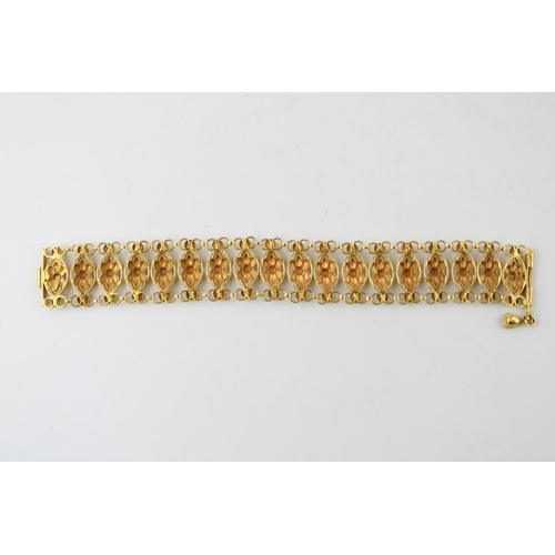 367 - An Indian gold bracelet, with eighteen panels each with faceted flower detail, with pin clasp, unmar... 