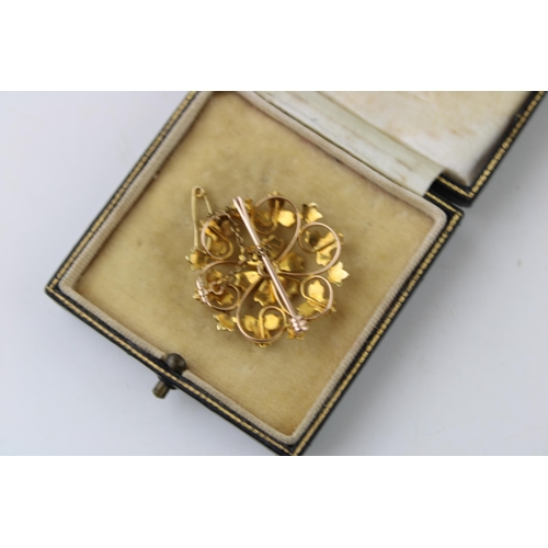 369 - Yellow metal (tests as 15ct gold) floral brooch, set seed pearls, with safety chain, 5.9g, in period... 