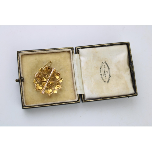 369 - Yellow metal (tests as 15ct gold) floral brooch, set seed pearls, with safety chain, 5.9g, in period... 