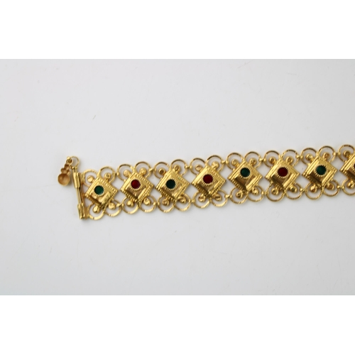 377 - Yellow metal (XRF tests as 18ct gold or better) bracelet, fancy links, enamelled coloured decoration... 