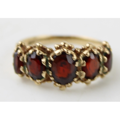 388 - 9ct gold garnet five stone ring, size O, 3.7g.