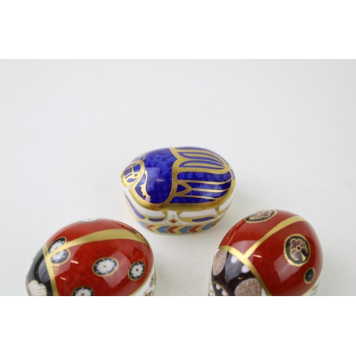 153 - Three Royal Crown Derby Paperweights, Red Ladybird with two spots and a Red Ladybird with seven spot... 