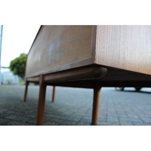 117A - A.H. Mcintosh Of Kirkcaldy retro 1960s teak sideboard raised on tapered legs. Approx 210 x 46 x 76cm... 