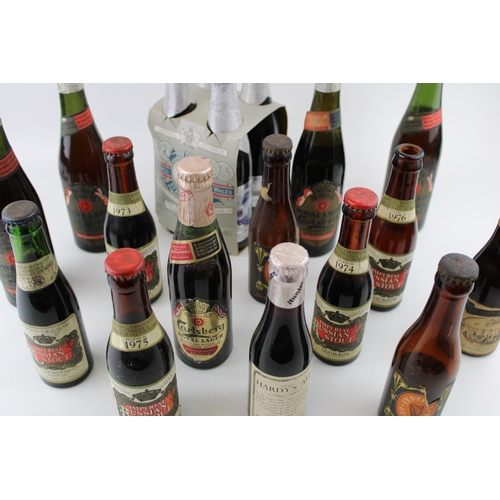 185A - A collection of vintage beer bottles mostly with contents to include special editions by 'Carlsberg'... 