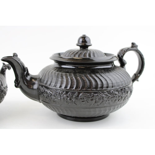 110 - A Victorian teapot together with sugar bowl (missing lid) in a Jackfield style. Height 14cm. (2)