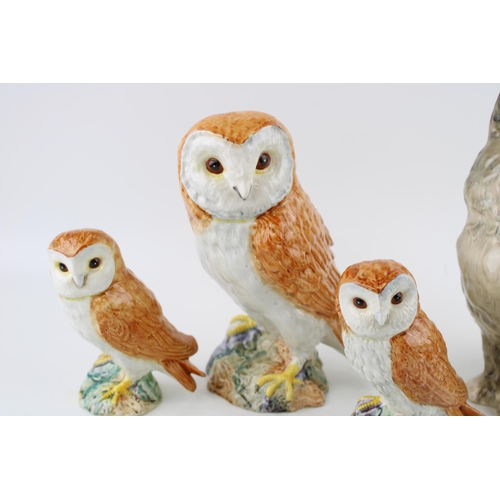 187 - A Beswick Cat together with three Beswick Barn Owls. (4) Height 21cm.