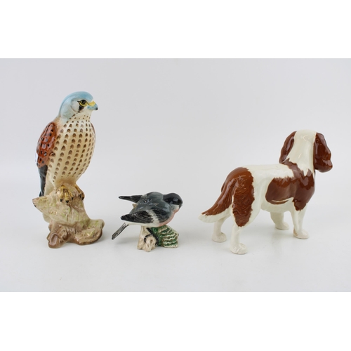 191 - A Beswick King Charles Spaniel together with a Kestrel and a Bullfinch. (3)