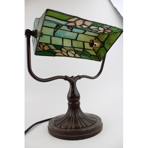 287 - A Tiffany style / stained glass banker's lamp with dragonfly design on cast metal base. Height 33cm.