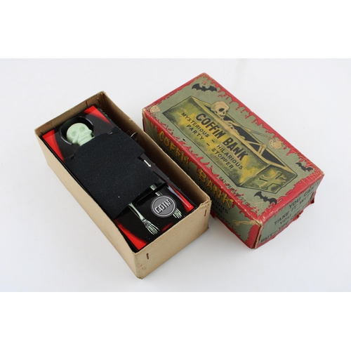 331 - A vintage Japan clockwork tin toy by Yone 'Coffin Bank' 'money bank with clockwork hand mechanism. H... 