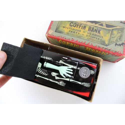 331 - A vintage Japan clockwork tin toy by Yone 'Coffin Bank' 'money bank with clockwork hand mechanism. H... 