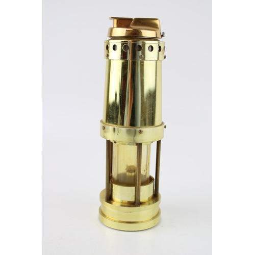 336 - Novelty brass effect table lighter in the form of a miner's lamp, 22cm tall.