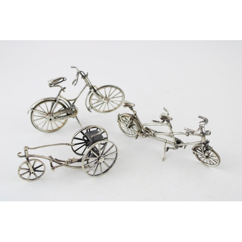 354 - A collection of silver jewellers toys in the form of bicycles. (3) 80g.