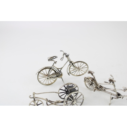 354 - A collection of silver jewellers toys in the form of bicycles. (3) 80g.