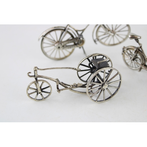 354 - A collection of silver jewellers toys in the form of bicycles. (3) 80g.