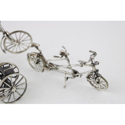 354 - A collection of silver jewellers toys in the form of bicycles. (3) 80g.