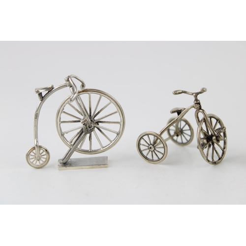 355 - A collection of silver jewellers toys in the form of bicycles. (4) 57g.