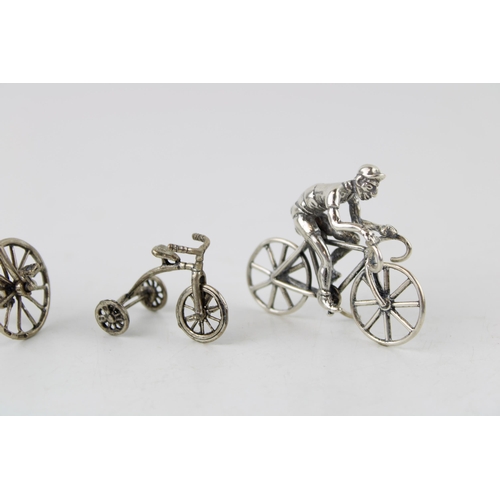 355 - A collection of silver jewellers toys in the form of bicycles. (4) 57g.