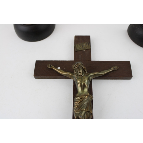 7 - Three vintage wooden crucifix's to include a pair on turned wooden bases together with a wall hangin... 