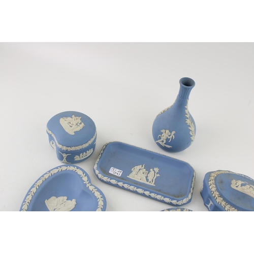 8 - A collection of Wedgwood Jasperware items to include pin trays, bud vase and lidded pots. (Qty)