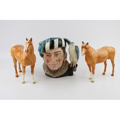 246 - Two Beswick palomino horses (1 ear af) and a large Royal Doulton character jug The Falconer (3).