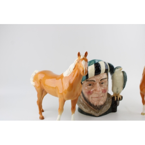 246 - Two Beswick palomino horses (1 ear af) and a large Royal Doulton character jug The Falconer (3).