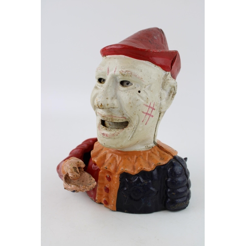 255 - A reproduction cast iron money box in the form of a clowns head. Height 20cm.