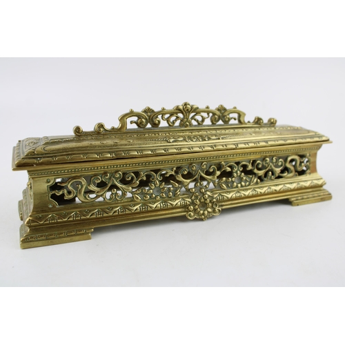 265 - An ornate brass ink stand with original ceramic liners. Width 25cm, height 8cm.