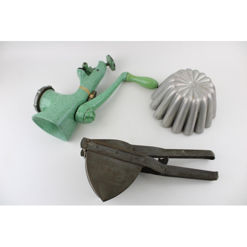 269 - A collection of kitchenalia items to include jelly mould, mincer and riser. (3)