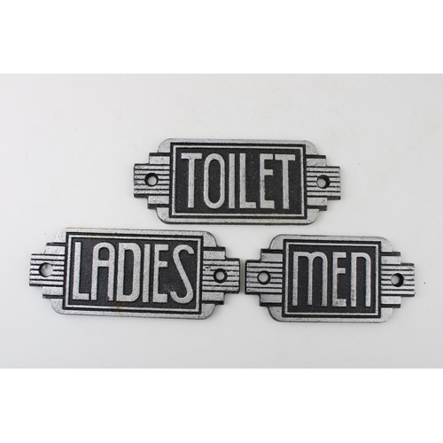 275 - A trio of reproduction cast metal Art Deco Toilet signs. Width 14.5cm.