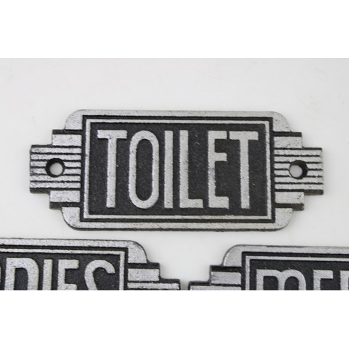 275 - A trio of reproduction cast metal Art Deco Toilet signs. Width 14.5cm.