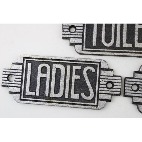 275 - A trio of reproduction cast metal Art Deco Toilet signs. Width 14.5cm.